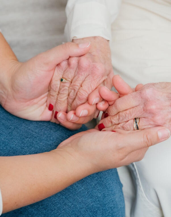 Older woman with red hair moves a magnet on a chart attached to her bathroom mirror Older woman with red hair moves a magnet on a chart attached to her bathroom mirror